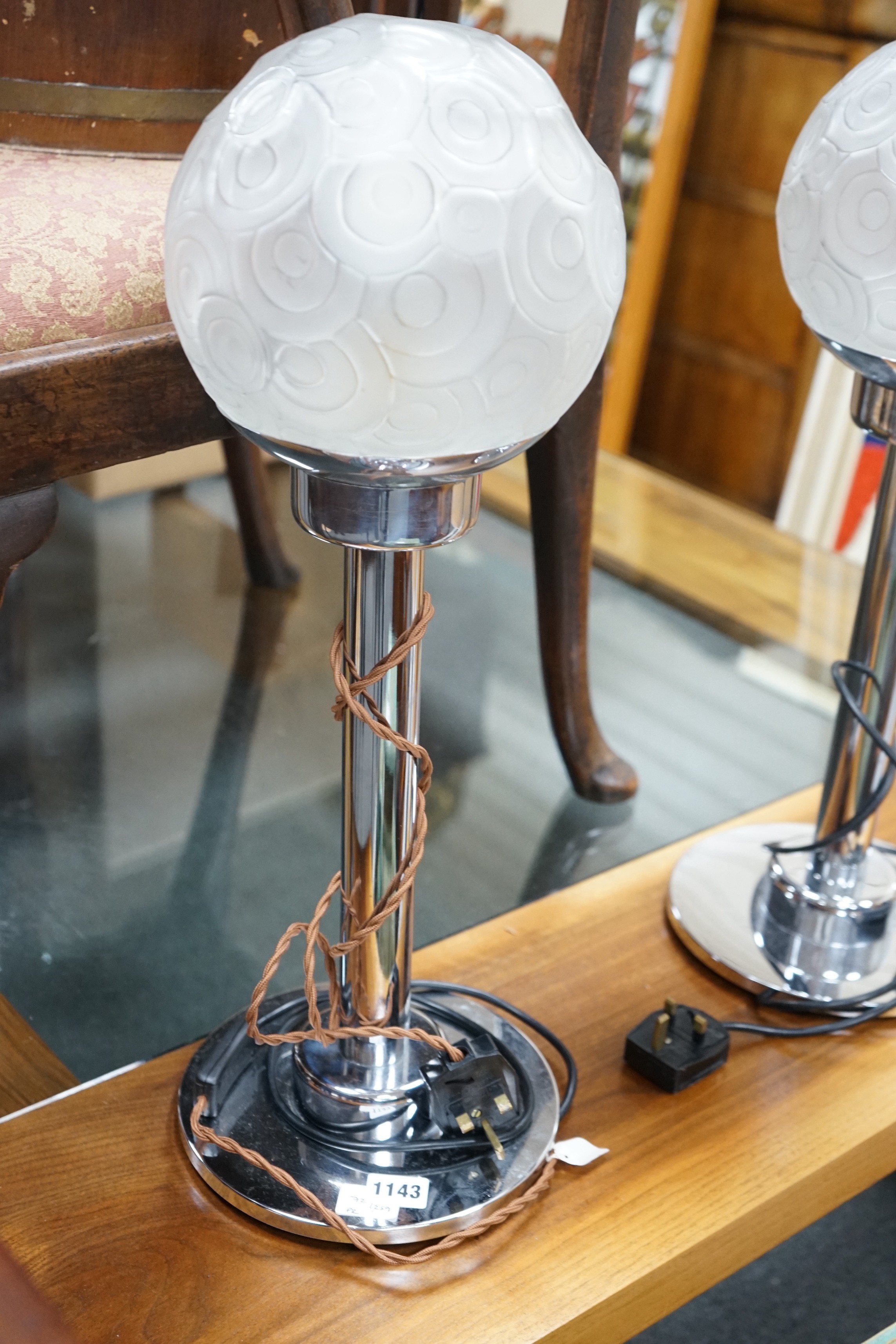 A pair of Art Deco style chrome and frosted glass lamps